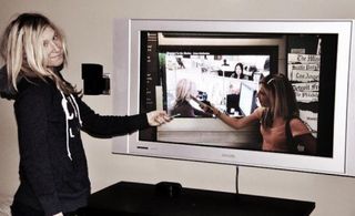 Amanda Caswell pointing to an image of her pointing to another image of her in an exhibit about Journalism at the Newseum in DC