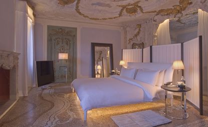 Bedroom painted in white stone sculpting and gold filigree