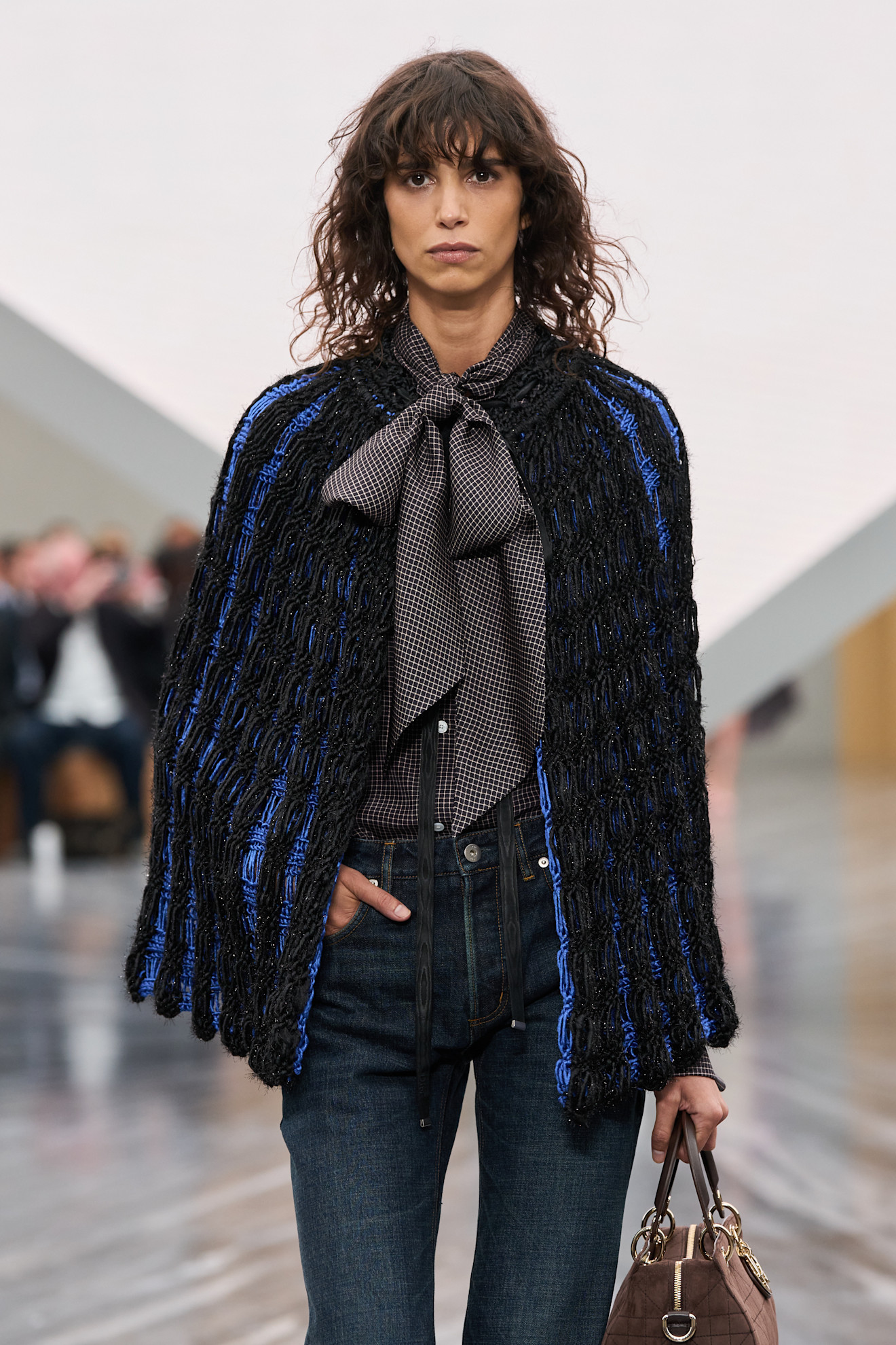 Woman in pussy bow blouse and jeans