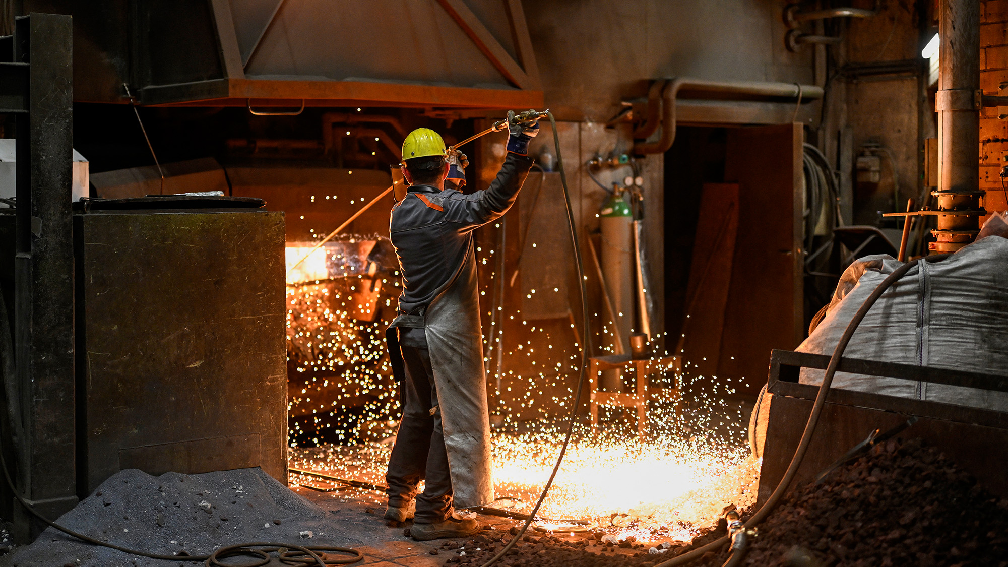 An employee smelts scrap metal at the electric arc furnace in Remscheid, Germany