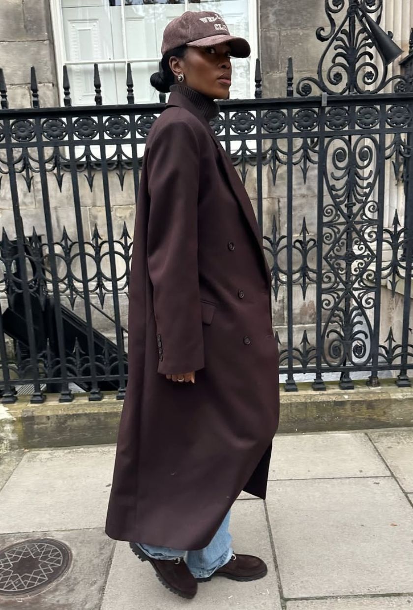 @nlmarilyn wears a long brown coat from The Frankie Shop