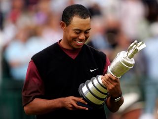 Tiger Woods smiles and looks at the Claret Jug after winning the 2005 Open