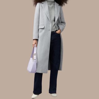 Flat lay image of a woman wearing a grey coat