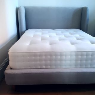 Woolroom Hebridean 3000 mattress on a grey upholstered bed frame