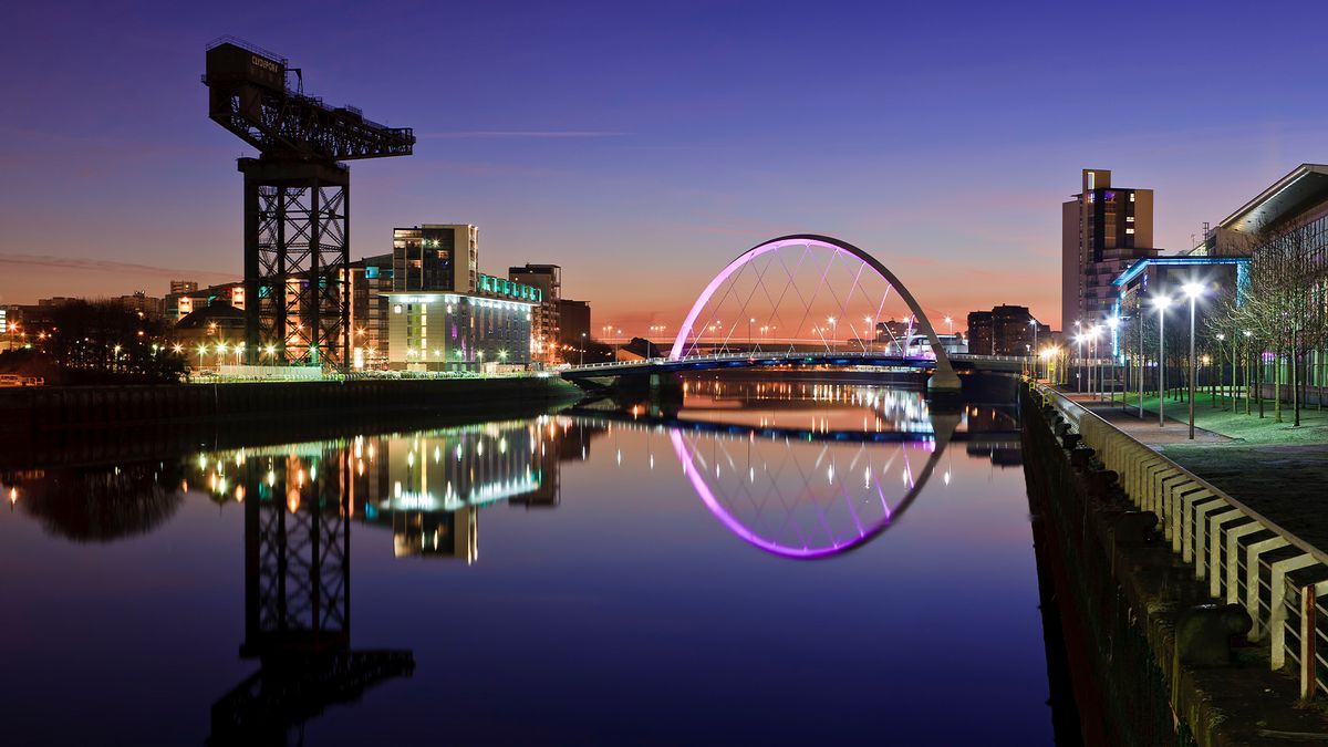 Glasgow pictured at dusk with the Finnieston crane and River Clyde in the foreground.