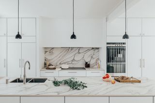 modern white kitchen with marble backsplash