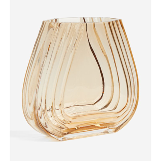 dark yellow tinted glass vase in a curved shape