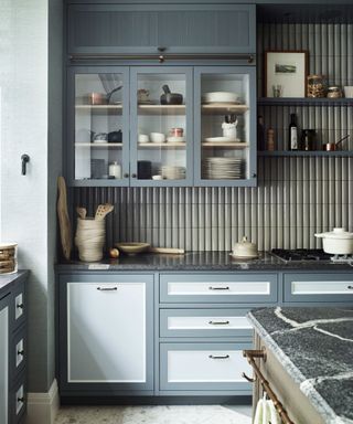 Blue kitchen with open shelving and glass fronted cabinetry