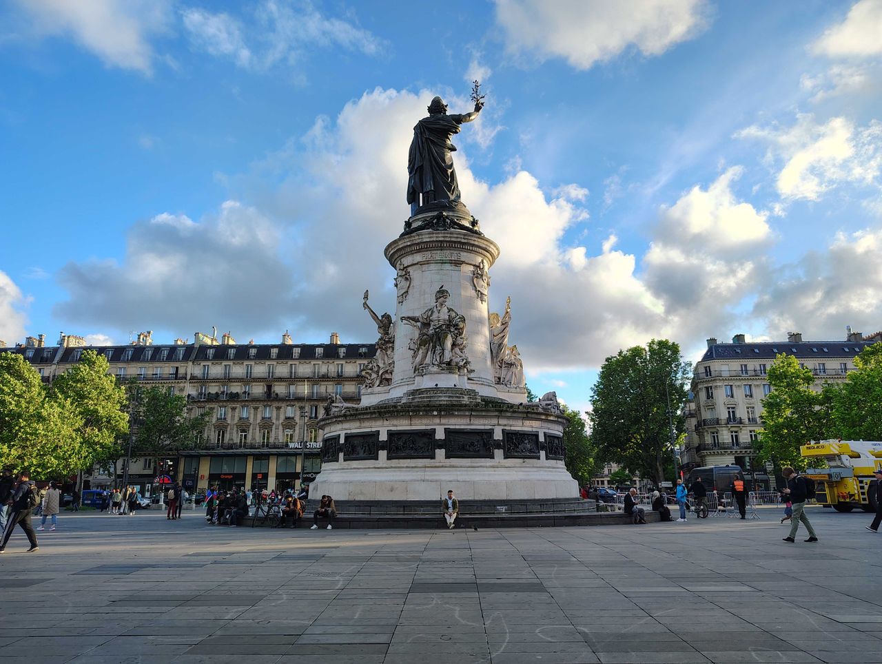 A statue with clouds in the background