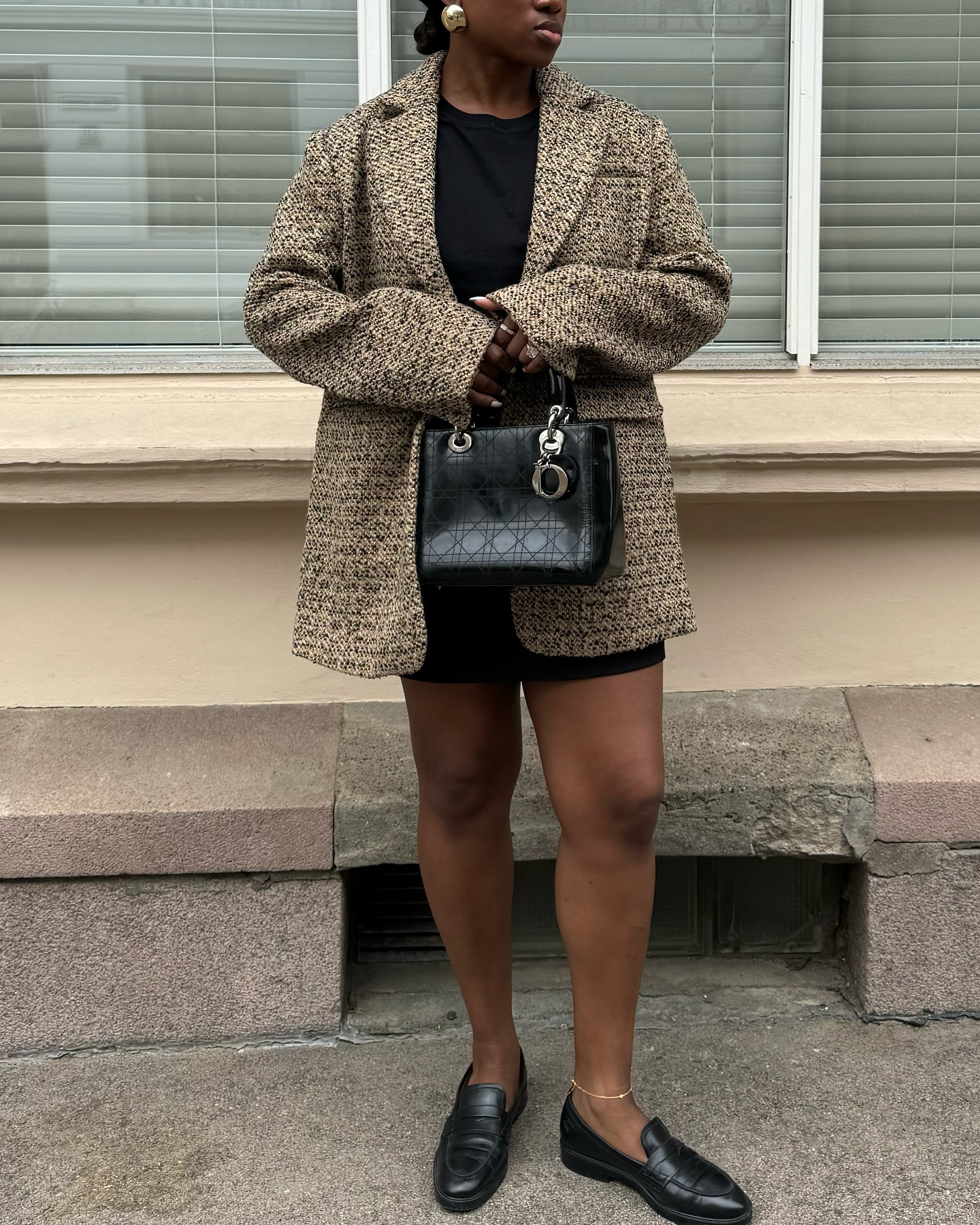 An image of @nnennaechem wearing a blazer with a dress, one of the biggest spring jacket trends to wear with jackets.