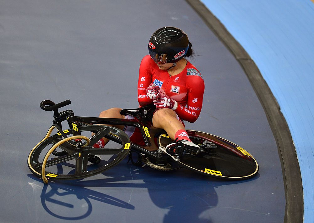 Sze Wai Lee of Hong Kong sits on the floor having has a crash while racing in the Women's Keirin during Day Two of the UCI Track Cycling World Championships