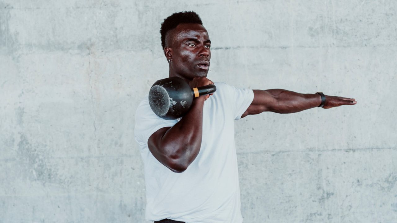 Man doing kettlebell squat