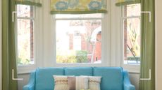 Living room bay window dressed with blue and green patterned roller blinds and green curtains