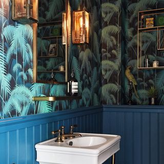 downstairs toilet with tropical wallpaper and blue wall panelling