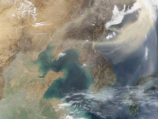 A tail of dust swirls over North Korea in this image taken by the MODIS instrument aboard NASA's Terra Satellite in April 2002. The dust was blowing from East Asia toward the Sea of Japan.