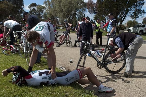 Peter Spencer (GE Plumbing) is comforted by an already injured teammate after a crash in the home straight.