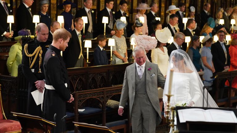 windsor, united kingdom may 19 prince harry looks at his bride, meghan markle, as she arrives accompanied by prince charles, prince of wales during their wedding in st georges chapel at windsor castle on may 19, 2018 in windsor, england photo by jonathan brady wpa poolgetty images