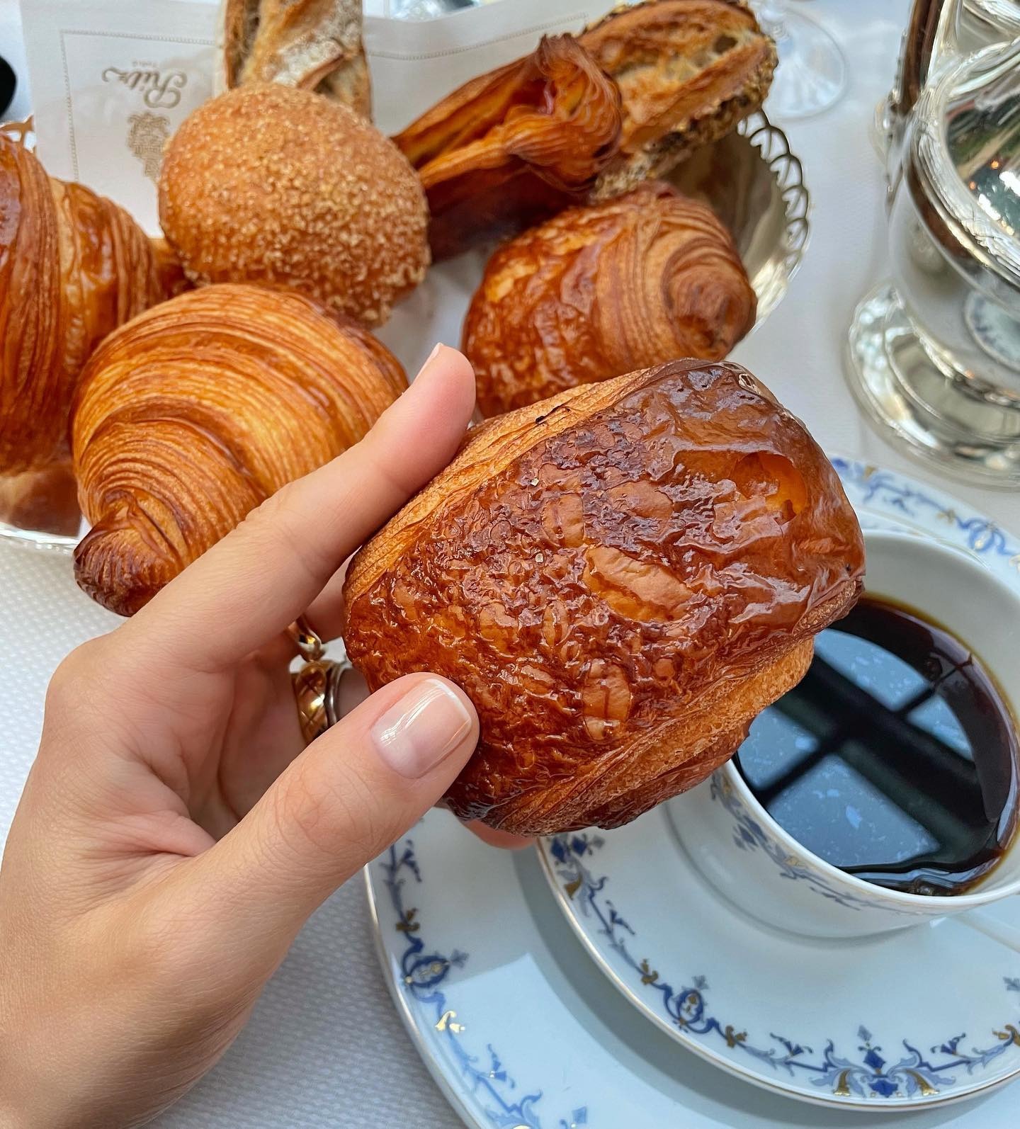 A picture of a restaurant table with a cup of coffee and an array of pastries