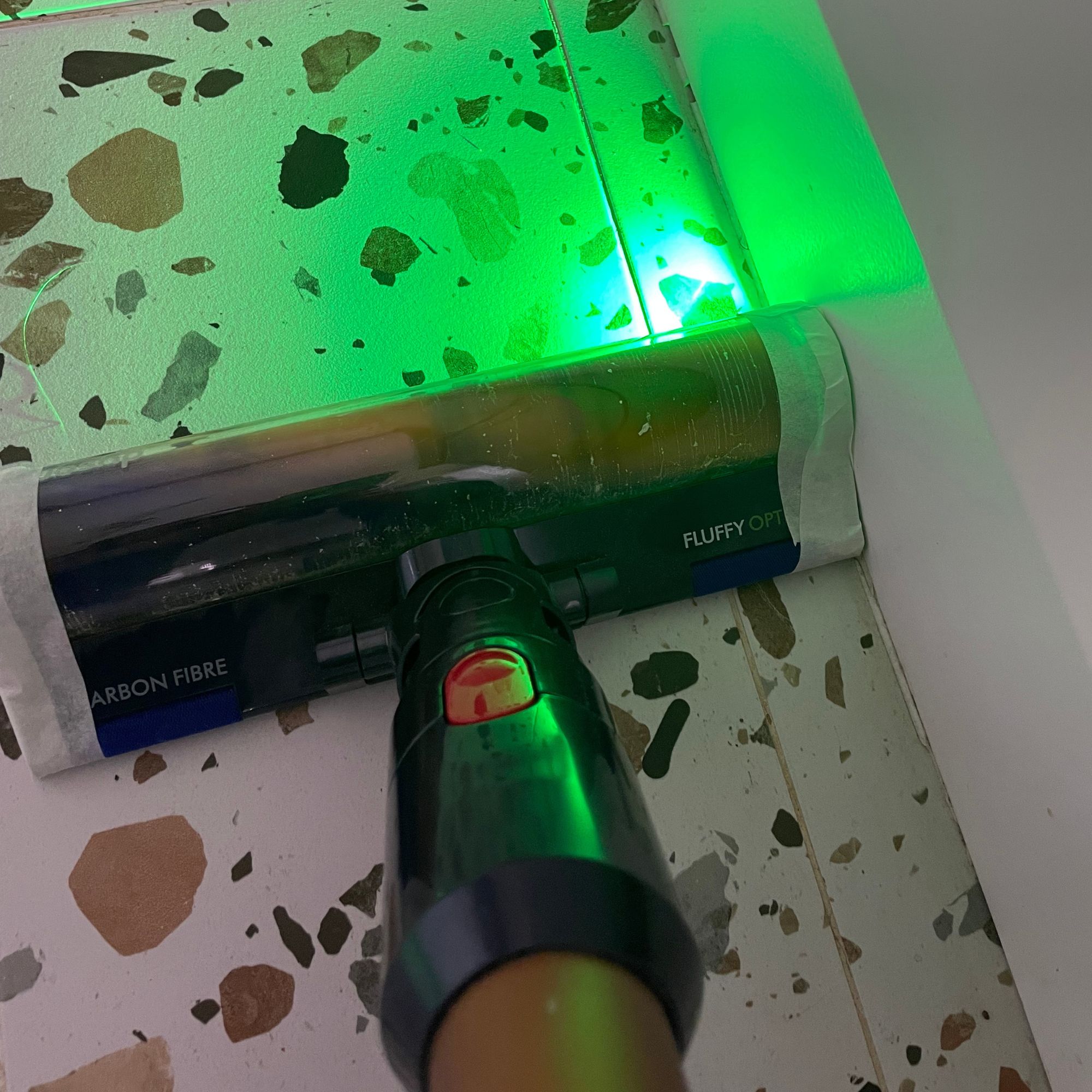 Dyson Gen5detect with masking tape around the edges cleaning terrazzo tiled floor