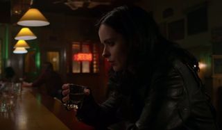 Marvel's Jessica Jones Jessica sits somberly at the bar with a shot in her hand