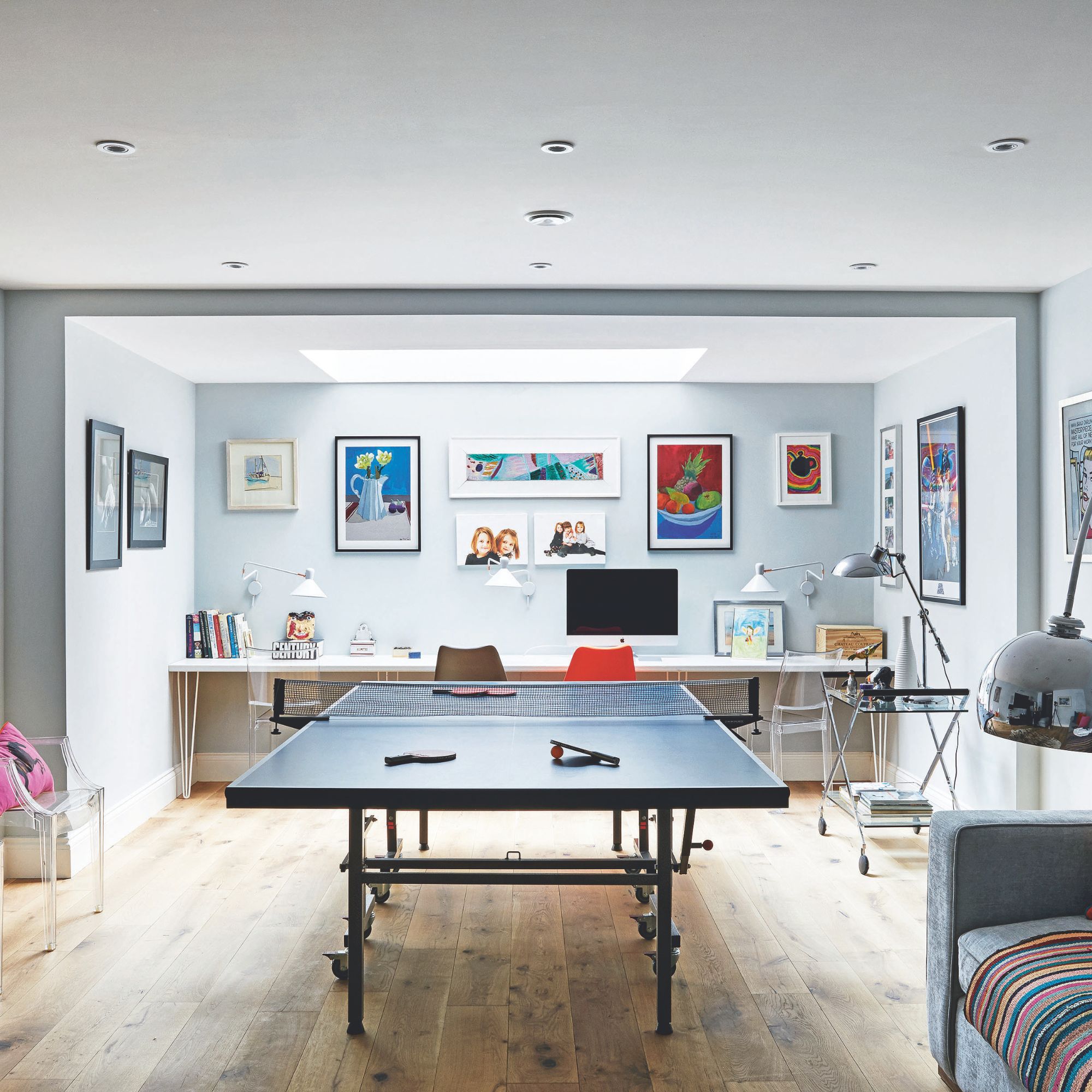 Games room in a converted basement, with light well bringing in some natural light