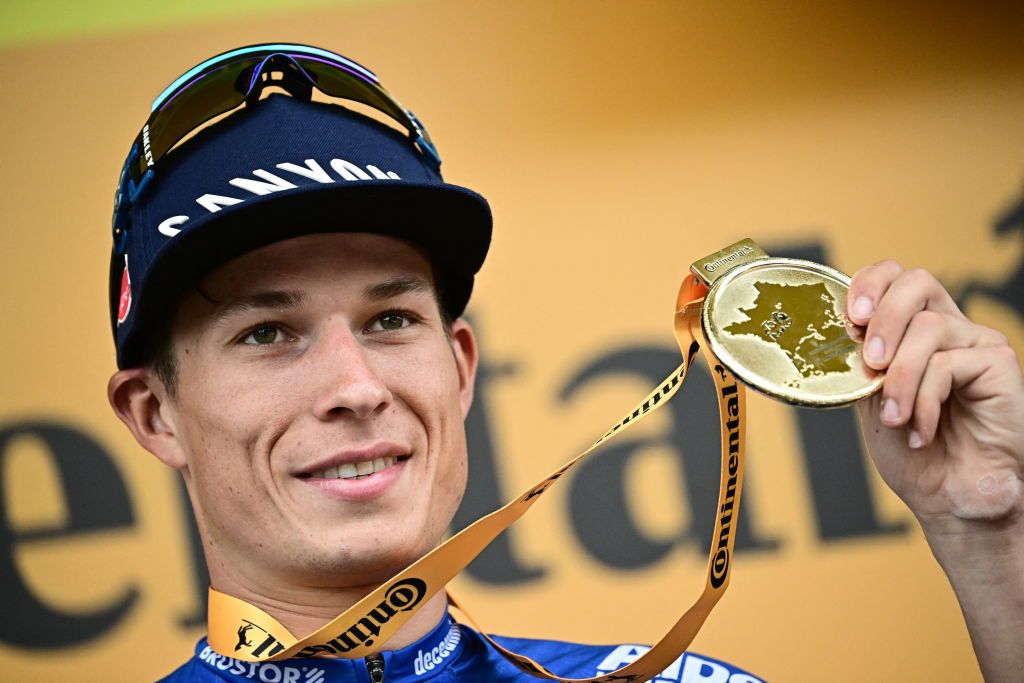 Alpecin-Deceuninck's Belgian rider Jasper Philipsen celebrates his victory on the podium after winning the 11th stage of the 110th edition of the Tour de France cycling race, 180 km between Clermont-Ferrand and Moulins, in central France, on July 12, 2023. (Photo by Marco BERTORELLO / AFP)