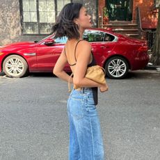 woman in black top and jeans