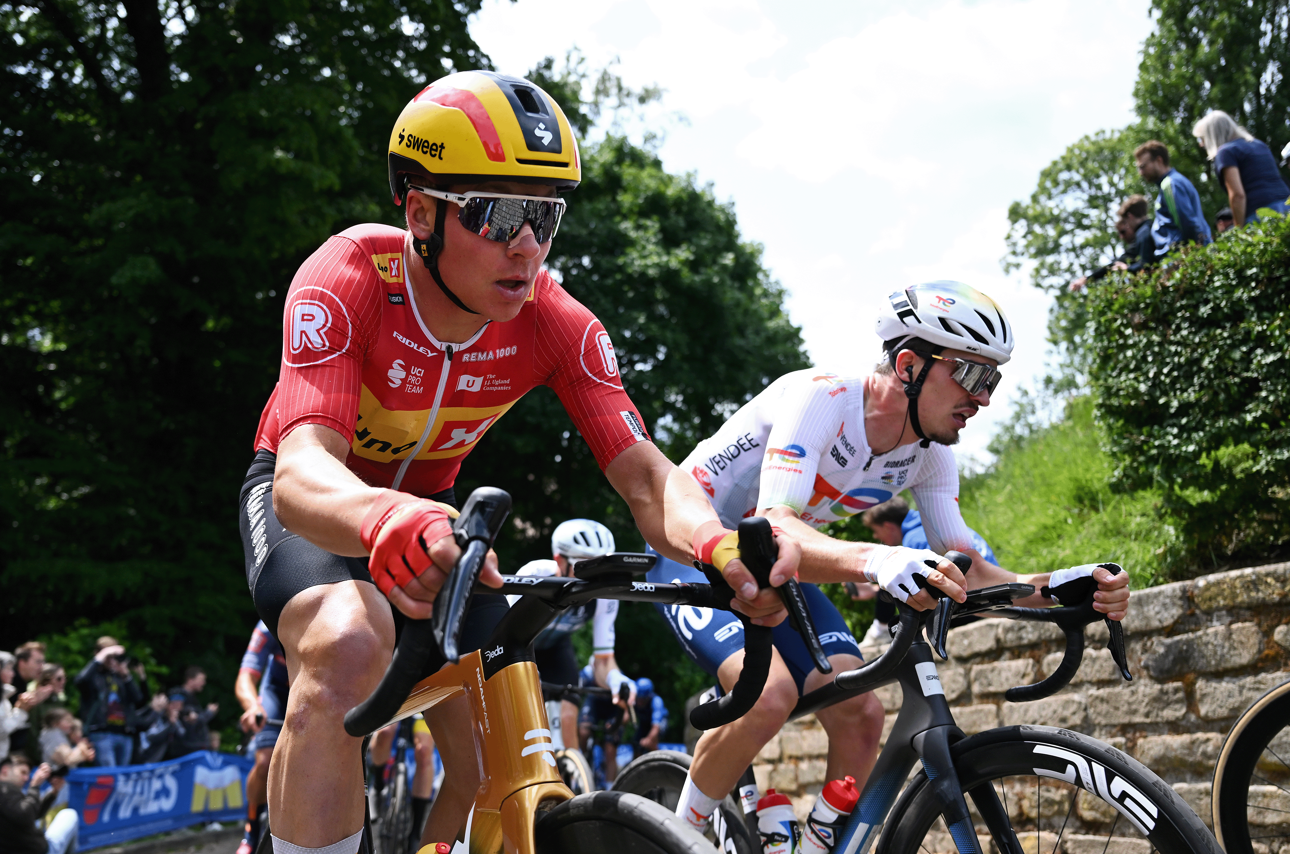 BRUSSELS, BELGIUM - JUNE 08: (L-R) Jonas Abrahamsen of Norway and Team Uno-X Mobility and Joris Delbove of France and Team TotalEnergies compete passing through the Muur van Geraardsbergen cobblestones sector during the 105th Brussels Cycling Classic 2025 a 205.5km one day race from Brussels to Brussels / #UCIWT / on June 08, 2025 in Brussels, Belgium. (Photo by Luc Claessen/Getty Images)