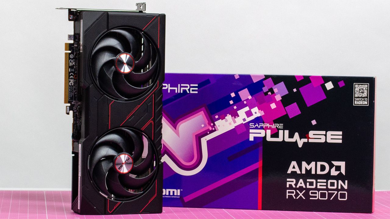 An AMD Radeon RX 9070 on a desk next to its retail packaging
