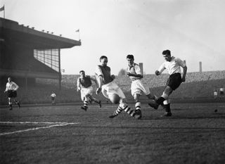 Tottenham's Len Duquemin shoots at goal in a game against Arsenal in February 1953.