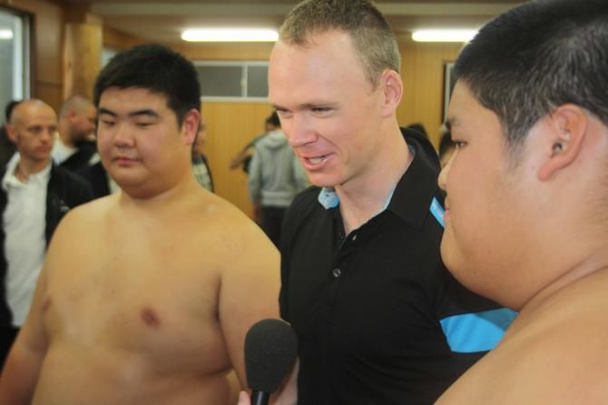 Chris Froome with a pair of his opponents in the sumo ring.
