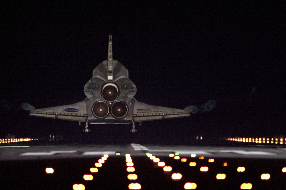 Runway lights help lead space shuttle Endeavour, seen here from behind, home to NASA&#039;s Kennedy Space Center in Florida. Endeavour landed for the final time on the Shuttle Landing Facility&#039;s Runway 15, on June 1, 2011, marking the 24th night landing of NAS