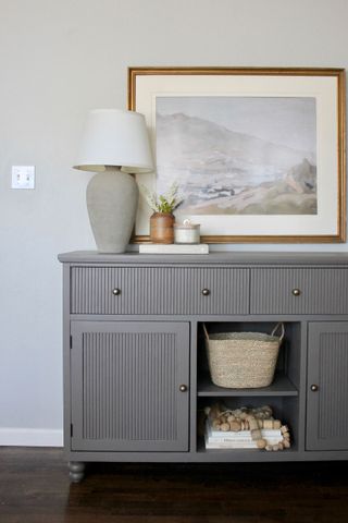 Pole wrap cabinet upcycled in grey staged in hallway with vase, frames and more decor