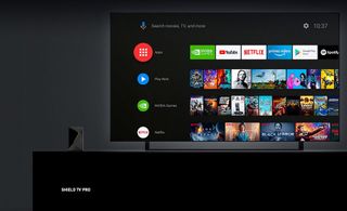 Size comparison of the Nvidia Shield TV Pro next to a 4K TV.
