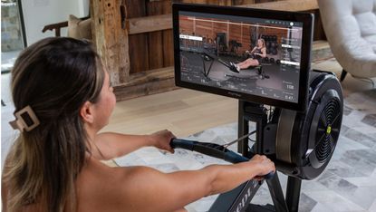 Women using a Concept2 rower with a Myrow screen attached