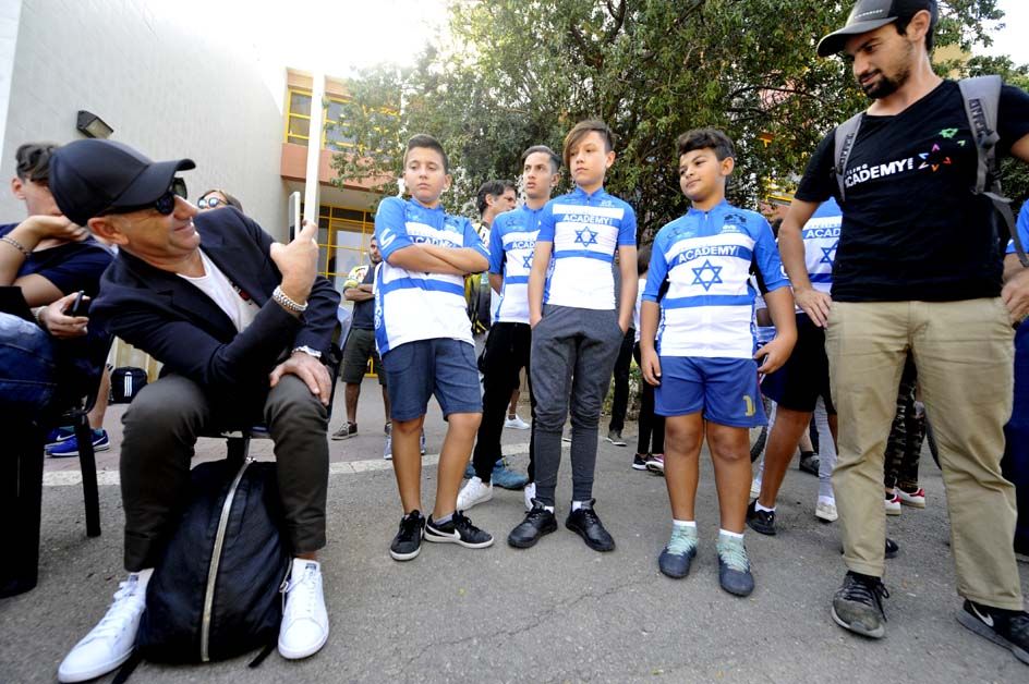 Cristiano de Rosa takes a picture of the children in their new kits