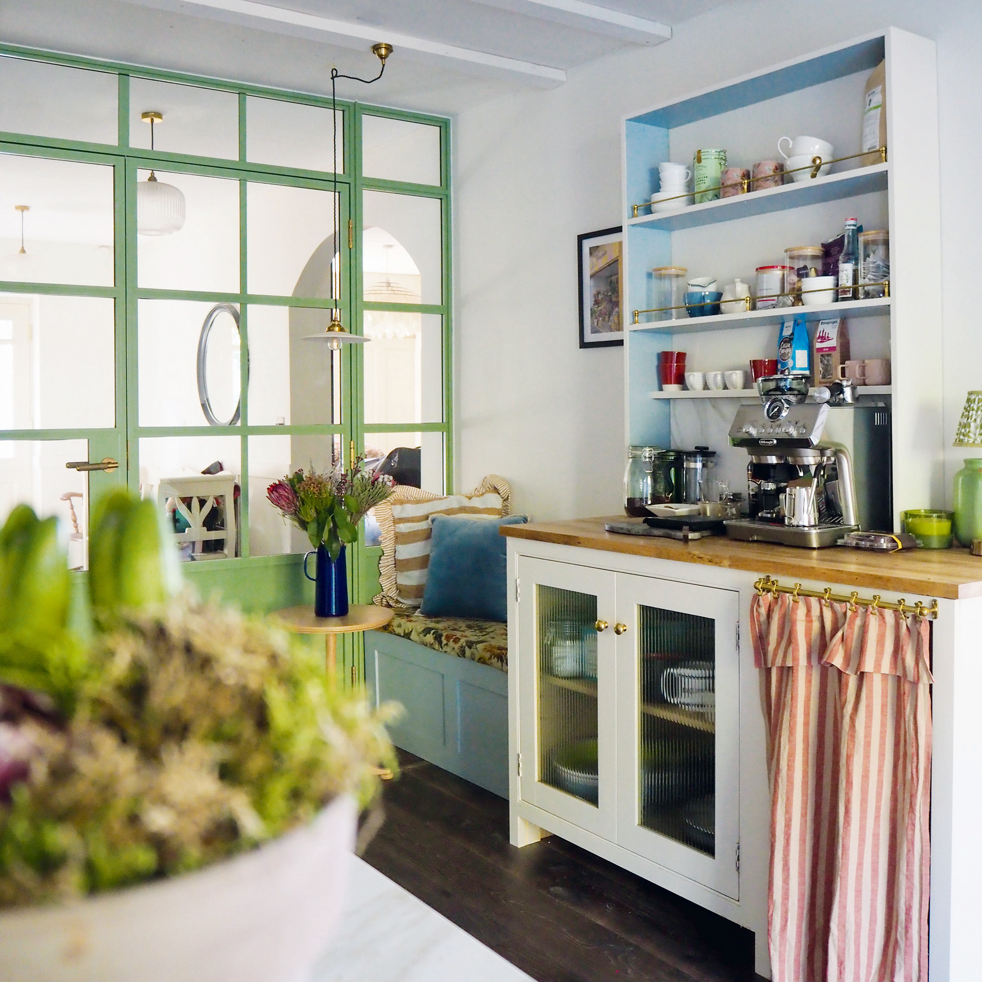 kitchen with neutral white walls and cabinetry and island with dark wood flooring and unpainted wooden unit cabinets