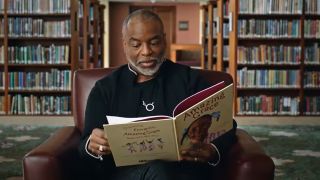 Levar Burton looking at a book in Reading Rainbow documentary