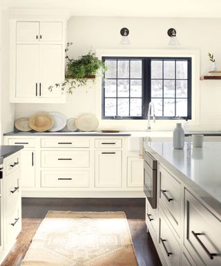 White kitchen with black hardware and window frames