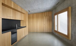 Interiors are kept simple with concrete walls, anhydrite floors and larch fittings