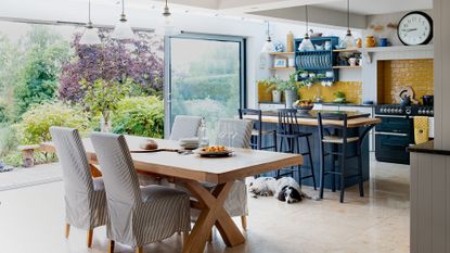 open plan kitchen with stone floor and glass doors