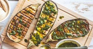 Grilled aubergines on a wooden board