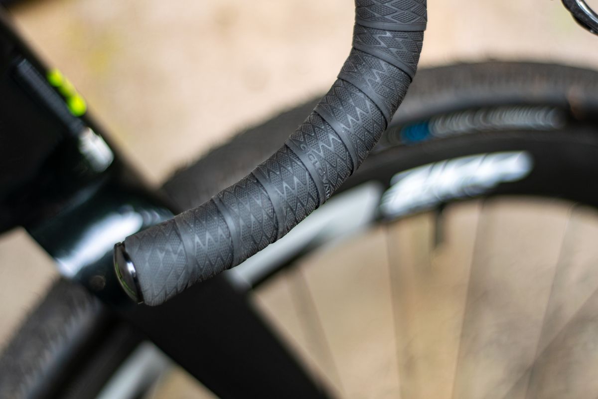 An Argon 18 Anti Matter gravel bike leaning against a concrete wall.