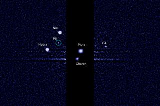 Pluto and its five moons – as seen from the Hubble Space Telescope in July, 2012.
