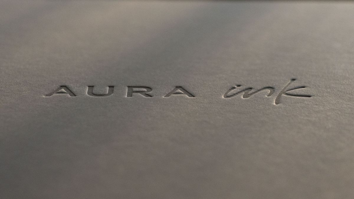 The close up of the Aura Ink 'E Ink' digital photo frame's presentation box, illuminated by the golden hour sun