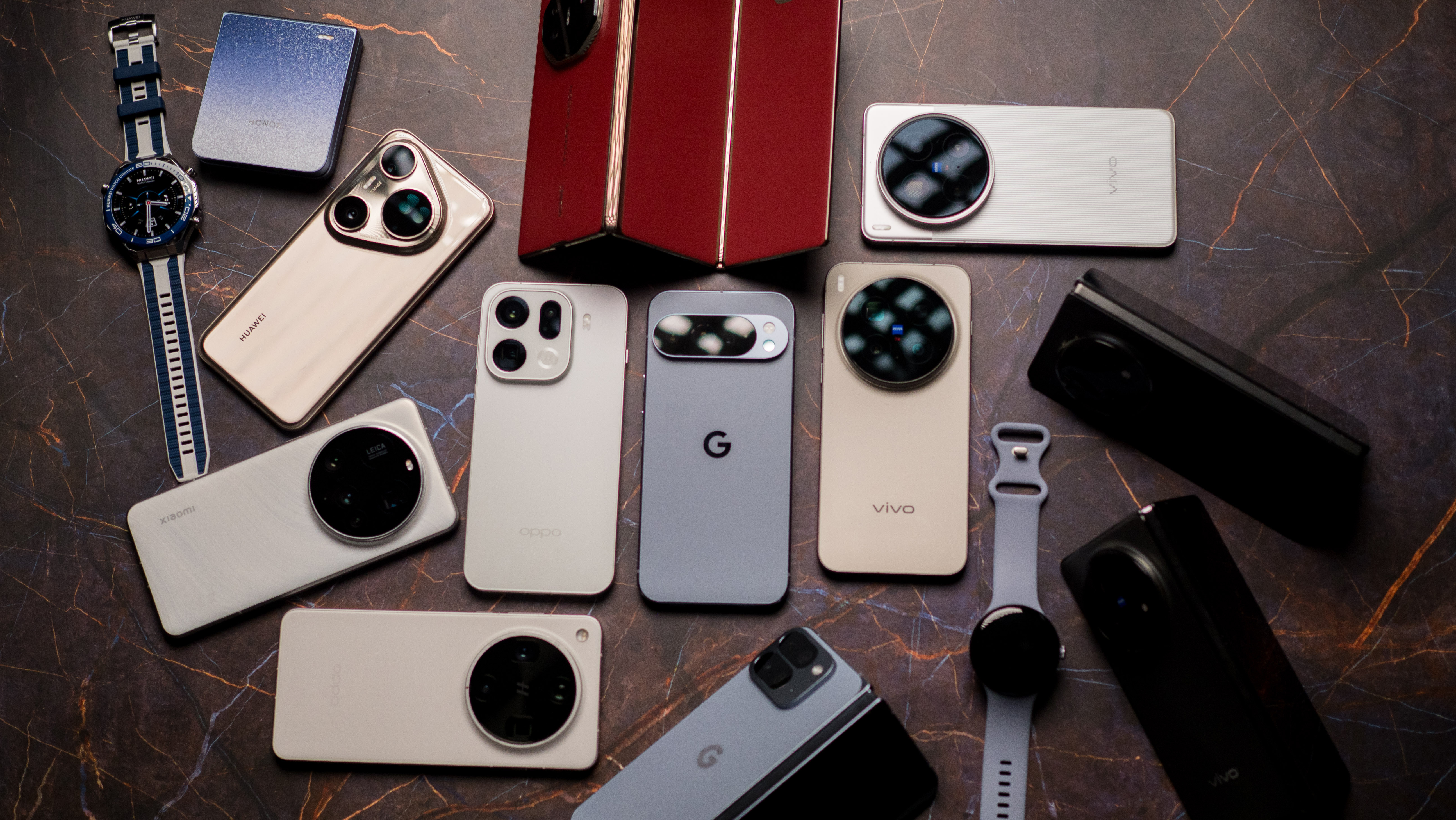 A spread of different phones and smart watches 