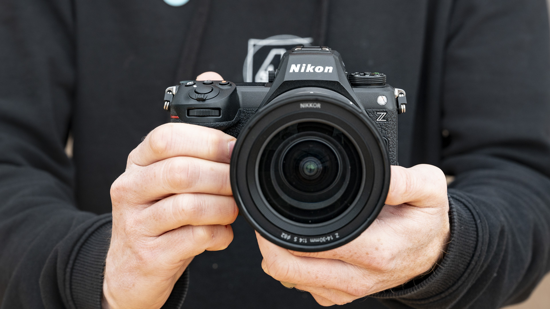 Nikon Z6 III camera in the hand, front on