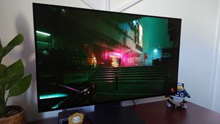 LG UltraGear 32GS95UE-B with Cyberpunk 2077 gameplay on screen