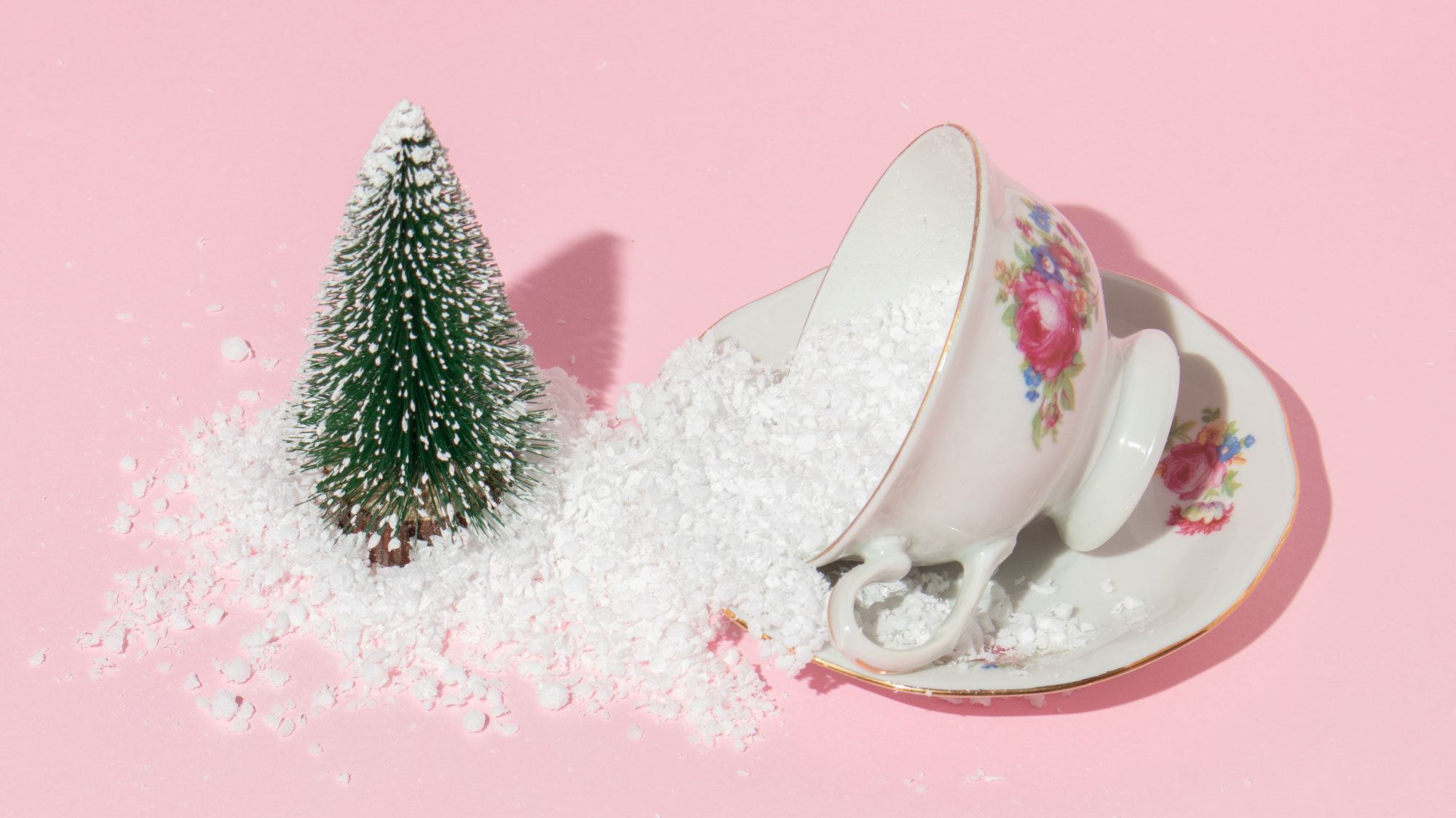 cup of sugar near miniature Christmas tree
