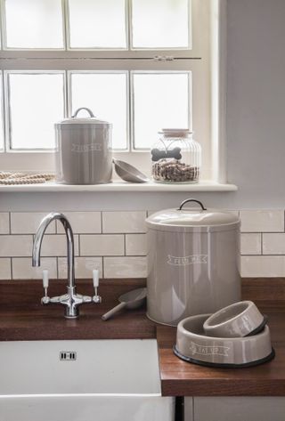 kitchen with storage jars and containers used to keep pet food by garden trading